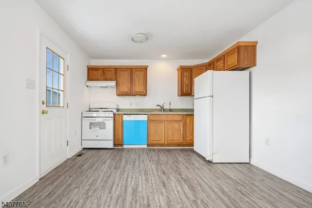 a kitchen with stainless steel appliances a stove a sink and a refrigerator