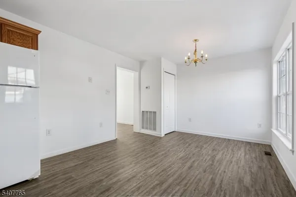 a view of a room with wooden floor