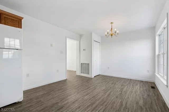 a view of a room with wooden floor