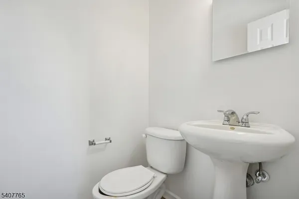 a bathroom with a sink a toilet and mirror