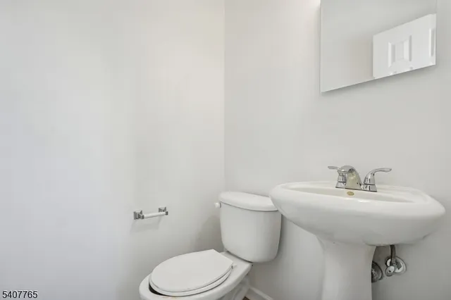 a bathroom with a sink a toilet and mirror