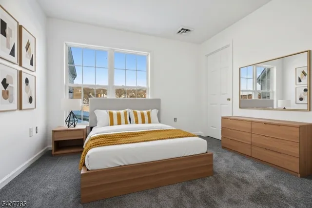 a bedroom with a bed and a dresser