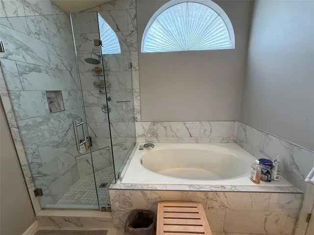 a bathroom with a tub and a shower