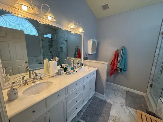 a bathroom with a double vanity sink and a mirror