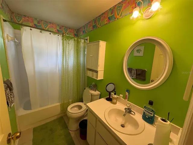 a bathroom with a sink mirror toilet and shower