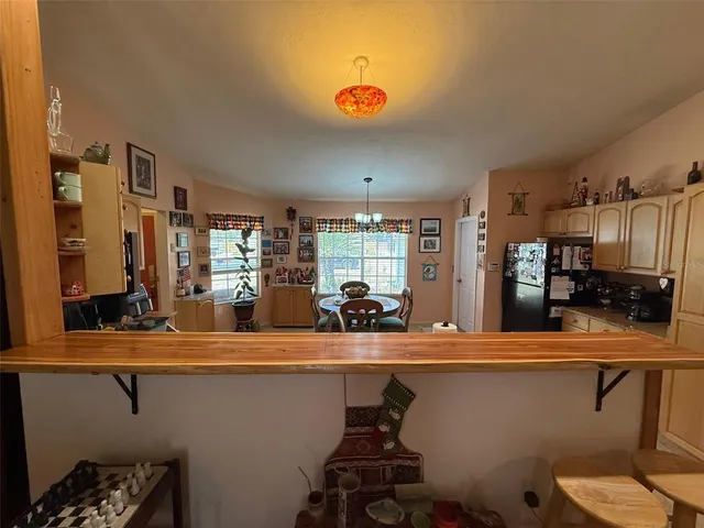 a kitchen with sink and view of living room