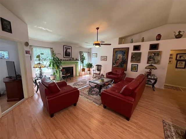 a living room with furniture flat screen tv and fireplace