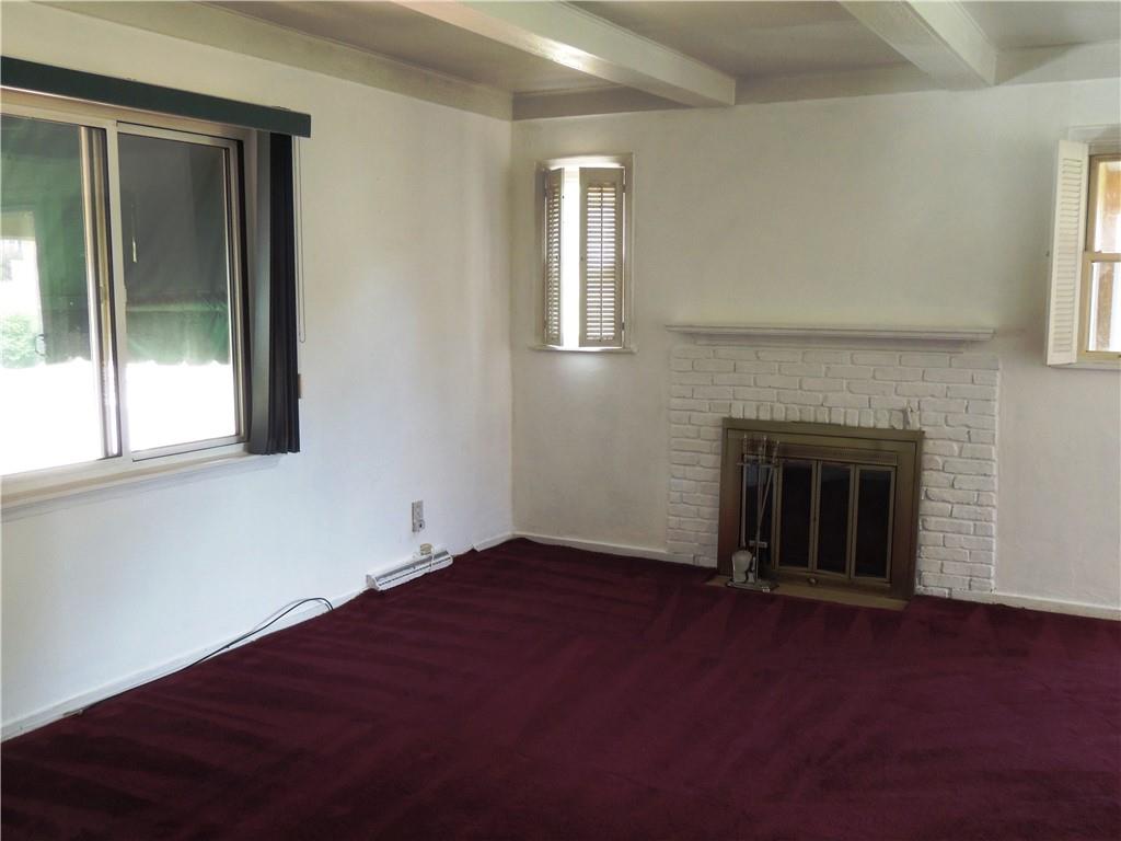 385 Rockhill Road Pittsburgh, PA 15243 - Photo 4 of 23 an empty room with windows and fireplace