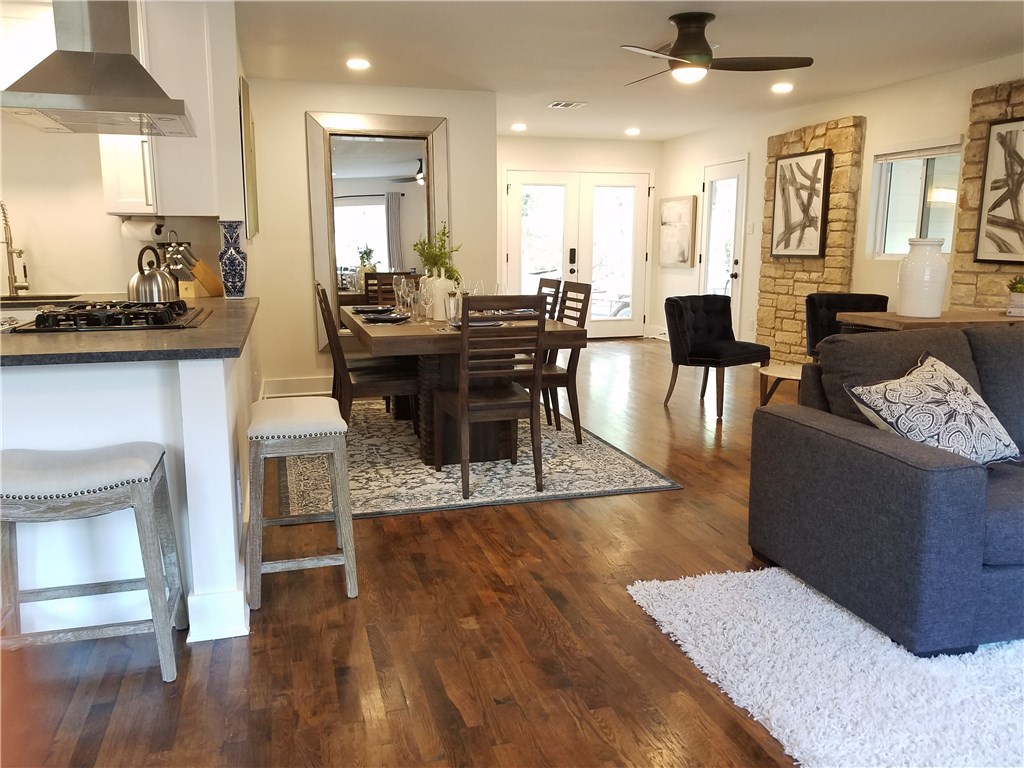 5405 Hudson Street Austin, TX 78721 - Photo 20 of 37 Rich hardwood floors unite an open concept living and dining area, flowing into a modern kitchen.