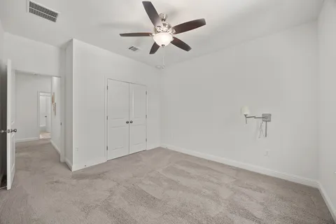 a view of room with window and ceiling fan