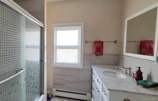 a bathroom with a granite countertop sink a vanity and window