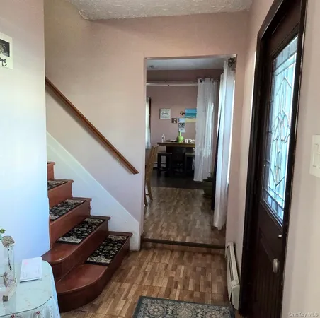a view of a hallway view with wooden floor and staircase