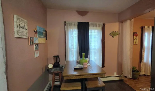 a view of a workspace room with furniture and wooden floor