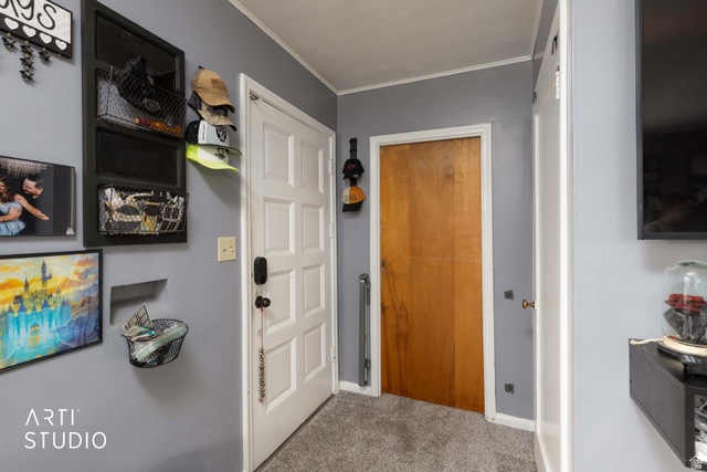 875 Patterson Street Ogden, UT 84403 - Photo 10 of 38 Entryway featuring carpet flooring and crown molding
