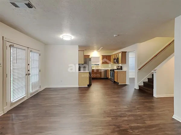 a view of kitchen and hall with wooden floor