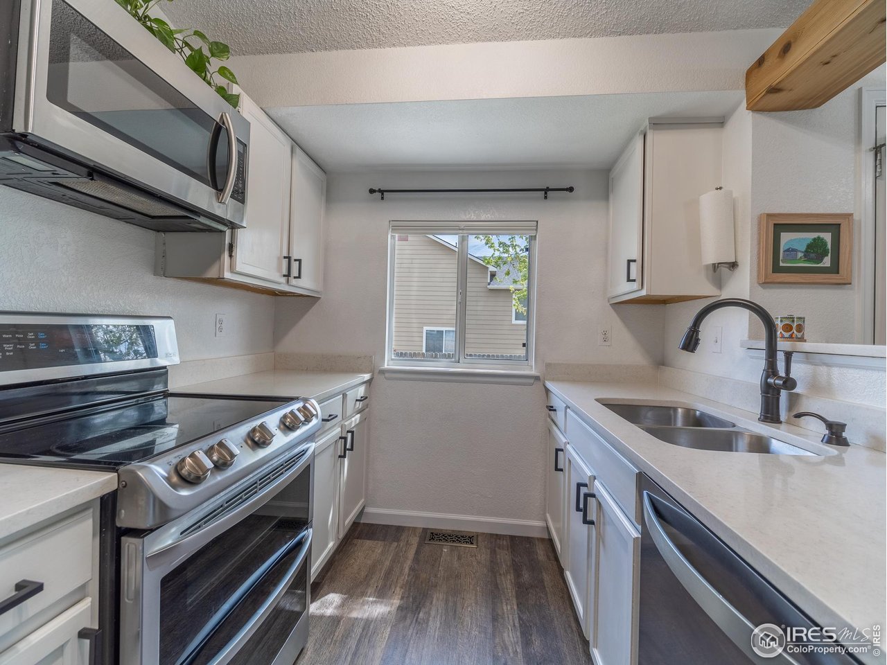 13146 Raritan Court Denver, CO 80234 - Photo 14 of 41 a kitchen with a sink stove and cabinets