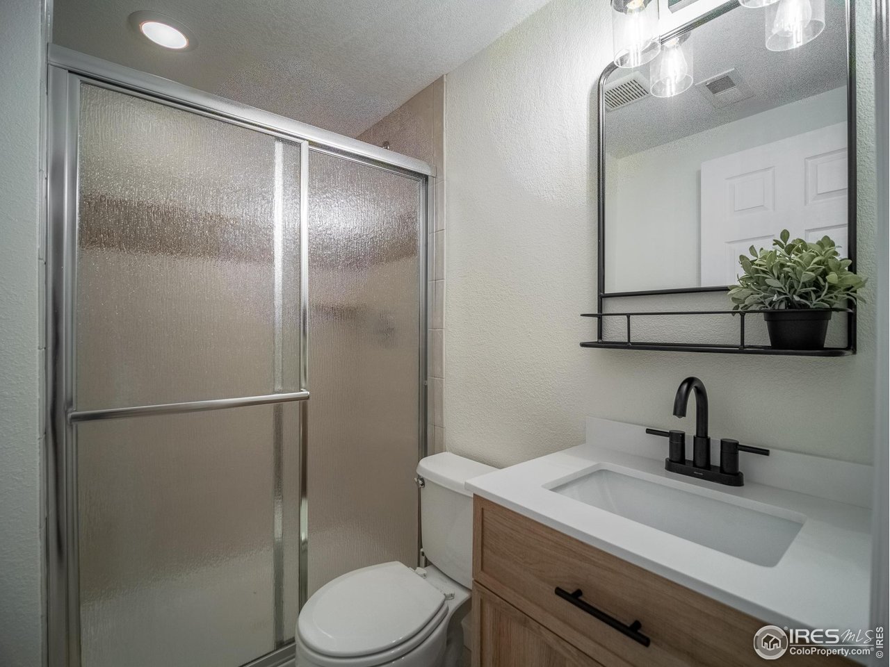 13146 Raritan Court Denver, CO 80234 - Photo 31 of 41 a bathroom with a toilet a sink and mirror