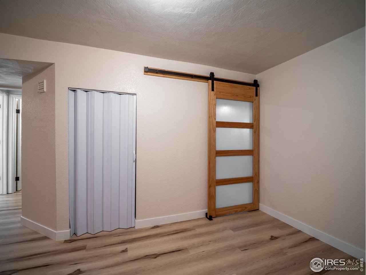13146 Raritan Court Denver, CO 80234 - Photo 36 of 41 a view of an empty room with wooden floor and closet