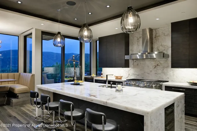 a kitchen with a table chairs sink and stove