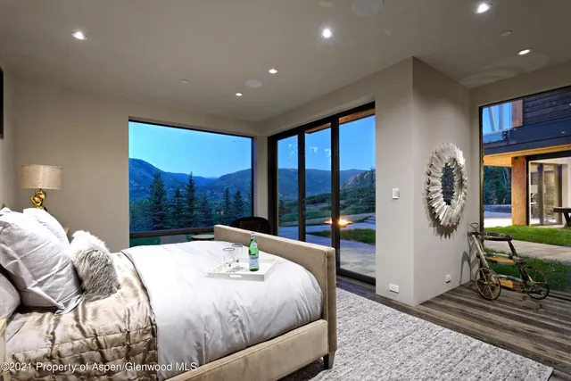 a large bedroom with a large bed and a large window