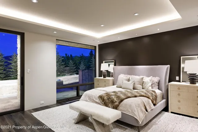 a bedroom with a large bed and a large window