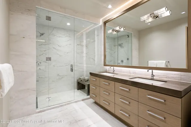 a bathroom with a granite countertop sink mirror and double
