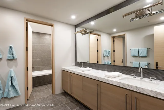 a bathroom with a double vanity sink and a mirror