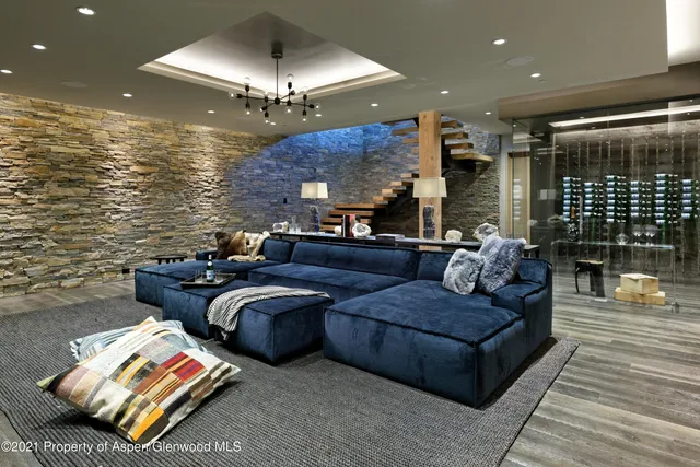 a living room with furniture and a chandelier