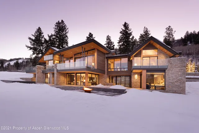 a porch with a bench and a floor to ceiling window