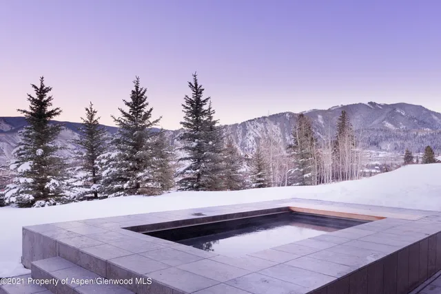 a view of swimming pool with a lounge chairs