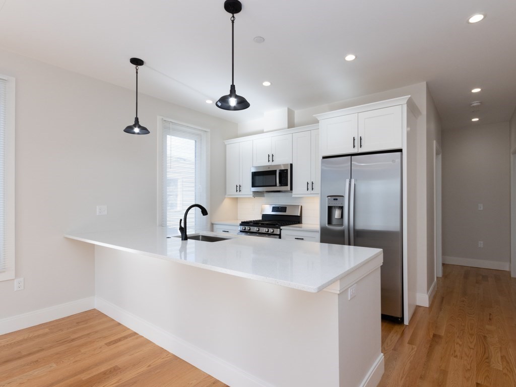 9 Tovar Street, Unit 2 Boston, MA 02122 - Photo 1 of 22 a kitchen with stainless steel appliances a refrigerator sink and microwave