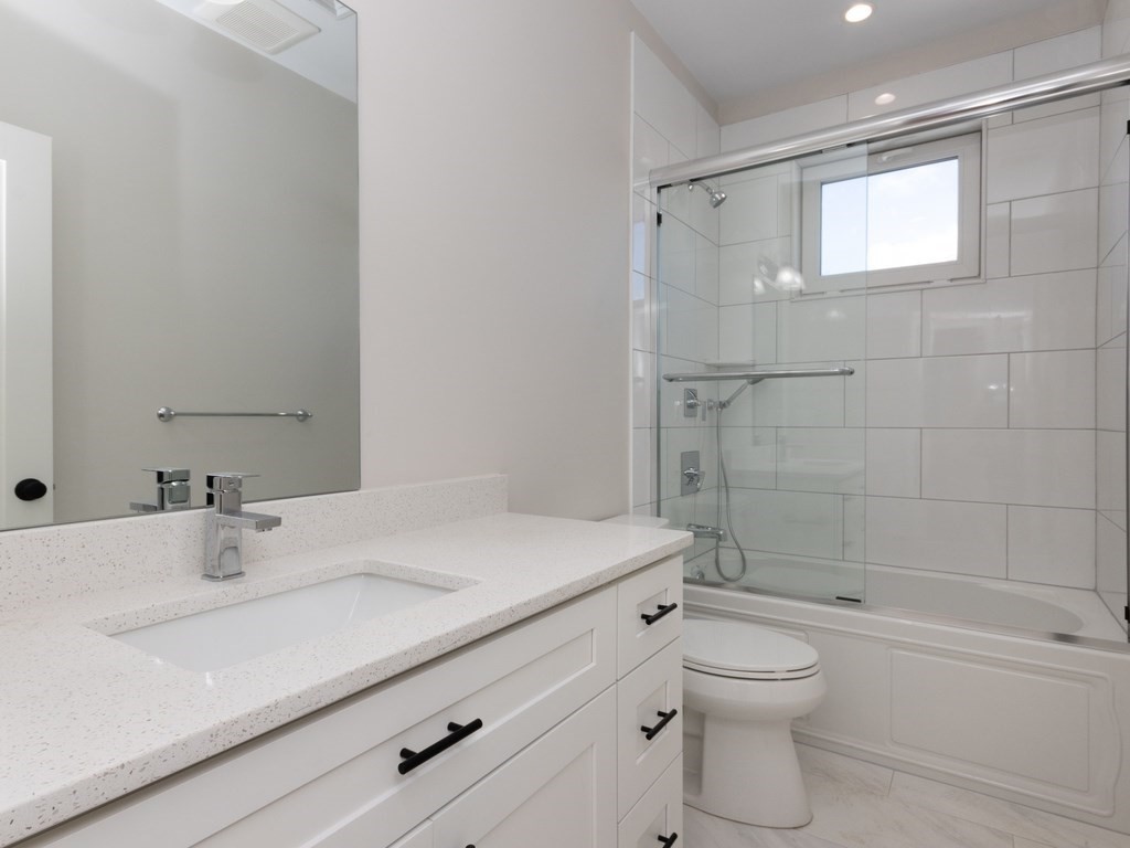 9 Tovar Street, Unit 2 Boston, MA 02122 - Photo 14 of 22 a bathroom with a sink a toilet and shower