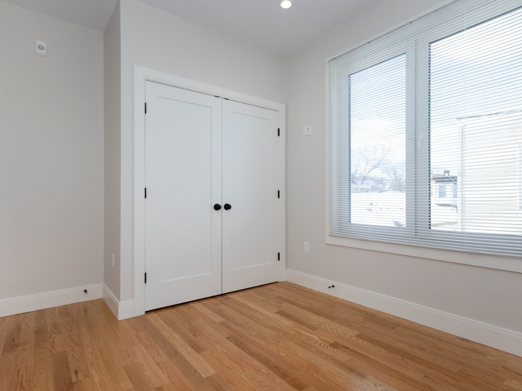 9 Tovar Street, Unit 2 Boston, MA 02122 - Photo 15 of 22 a view of empty room with wooden floor and fan