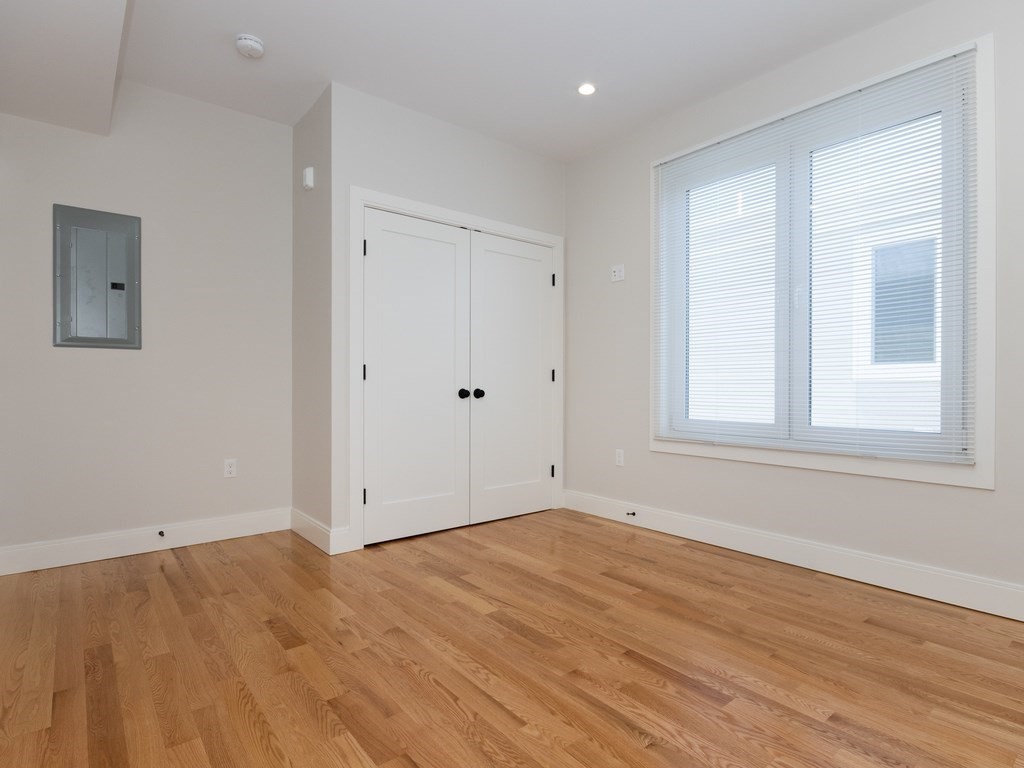 9 Tovar Street, Unit 2 Boston, MA 02122 - Photo 16 of 22 a view of an empty room with wooden floor