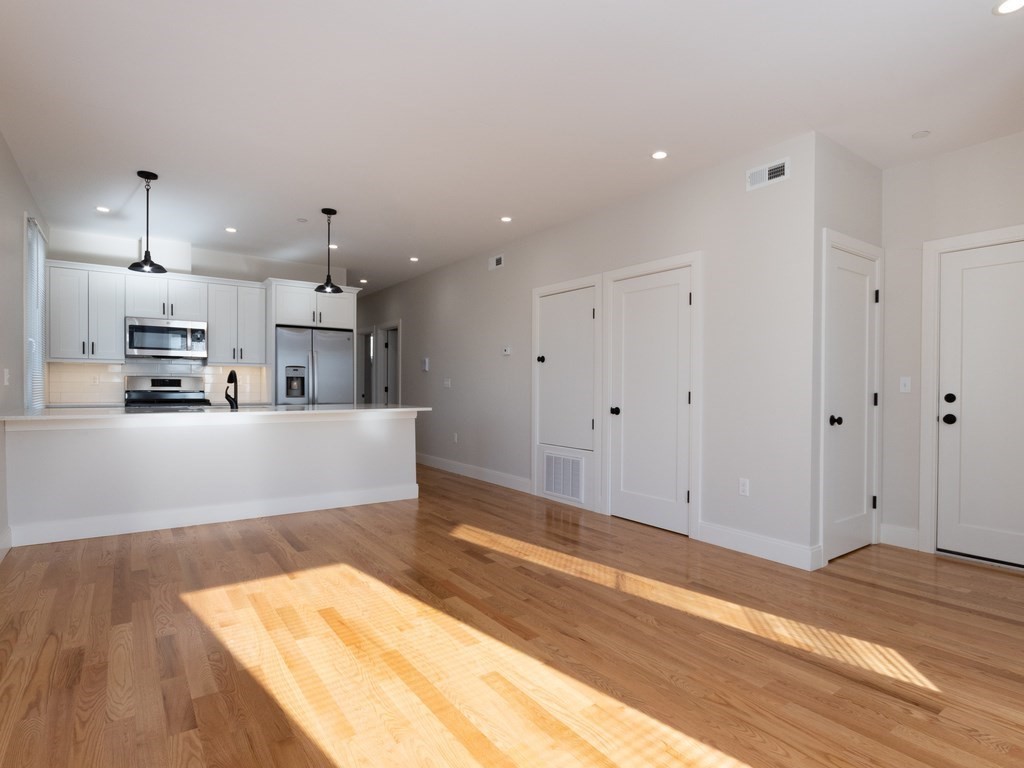 9 Tovar Street, Unit 2 Boston, MA 02122 - Photo 5 of 22 a view of kitchen with wooden floor