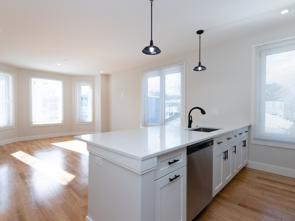 9 Tovar Street, Unit 2 Boston, MA 02122 - Photo 6 of 22 a kitchen with a sink stove and cabinets