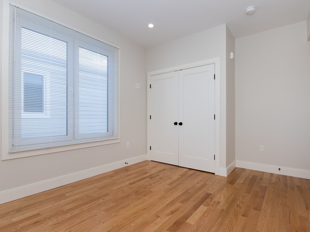 9 Tovar Street, Unit 2 Boston, MA 02122 - Photo 8 of 22 a view of empty room with wooden floor and fan