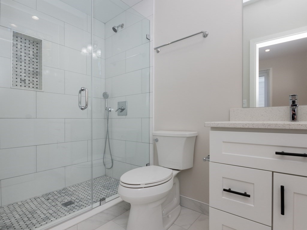 9 Tovar Street, Unit 2 Boston, MA 02122 - Photo 10 of 22 a bathroom with a sink a toilet and shower