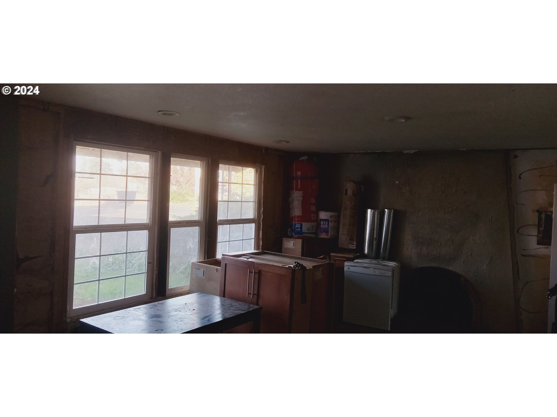 17126 Southeast Bush Street Portland, OR 97236 - Photo 8 of 17 a living room with furniture and floor to ceiling window