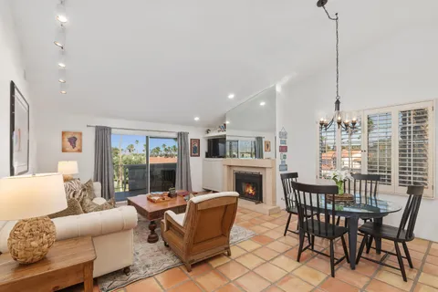 a living room with furniture a fireplace and a table