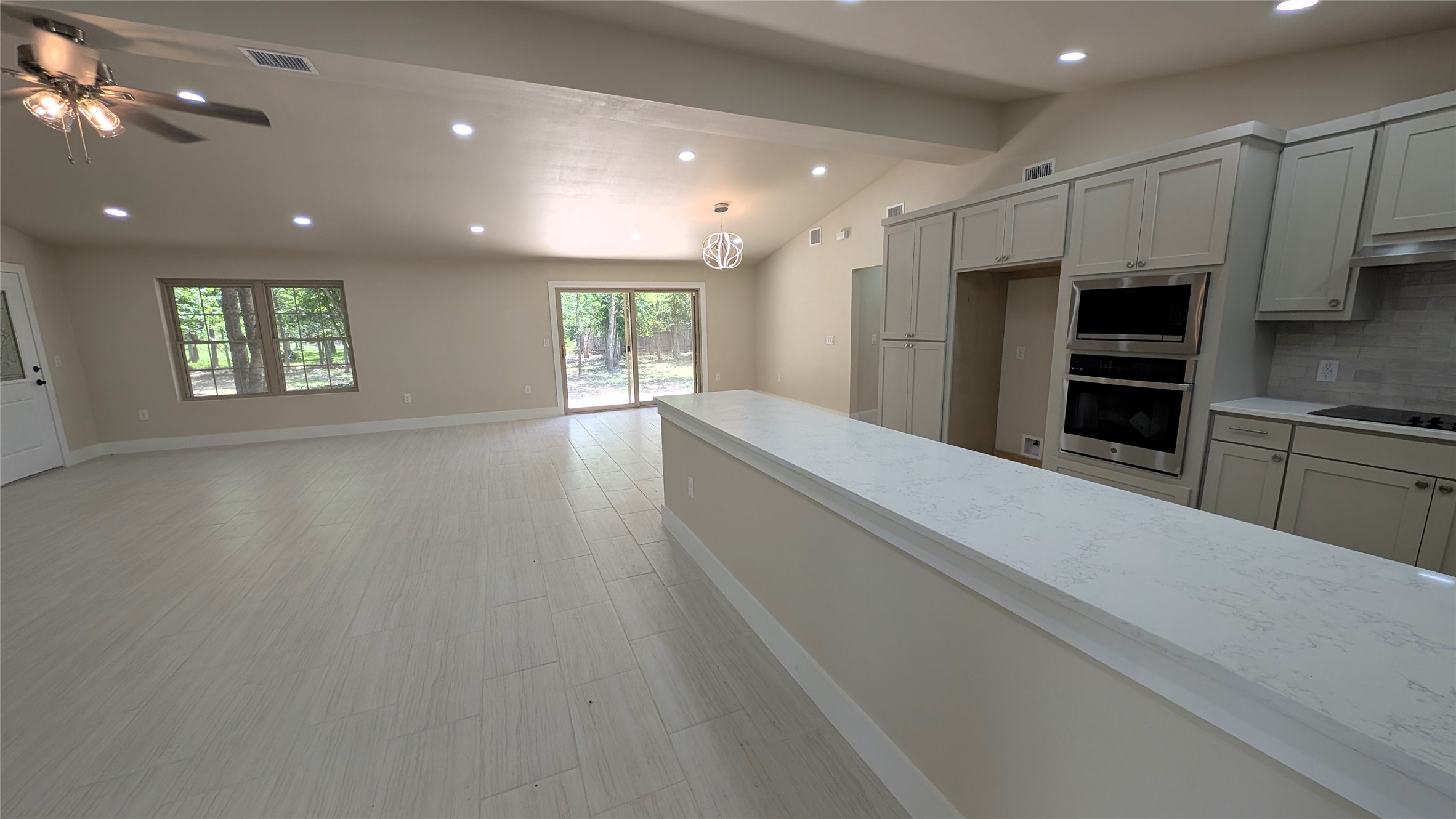 11811 Sleepy Hollow Road Manchaca, TX 78652 - Photo 4 of 31 a view of kitchen with kitchen island microwave and window
