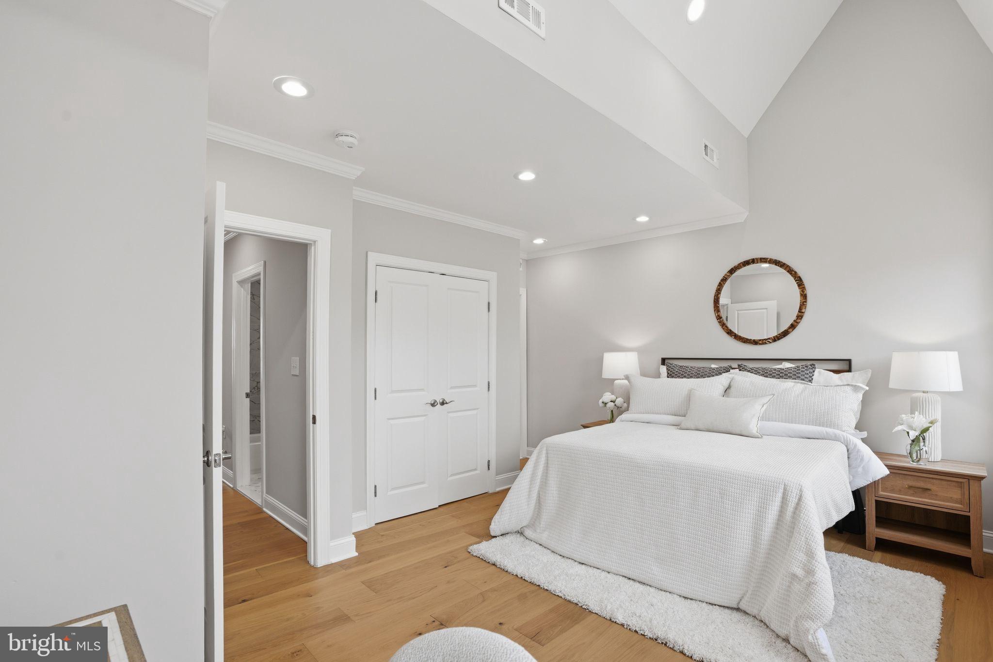 1208 Shepherd Street Northwest Washington, DC 20011 - Photo 19 of 27 a bedroom with a bed and a chandelier