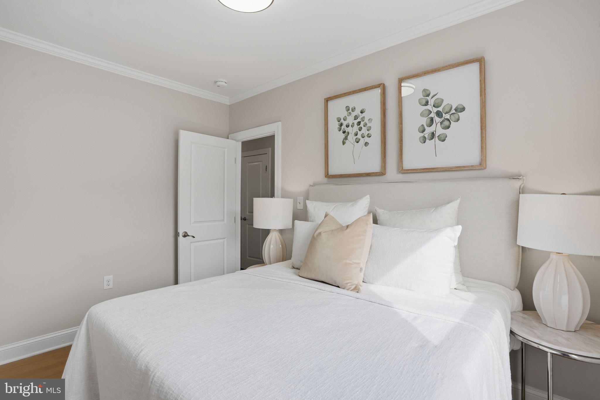 1208 Shepherd Street Northwest Washington, DC 20011 - Photo 21 of 27 a bedroom with a bed and painting on the wall
