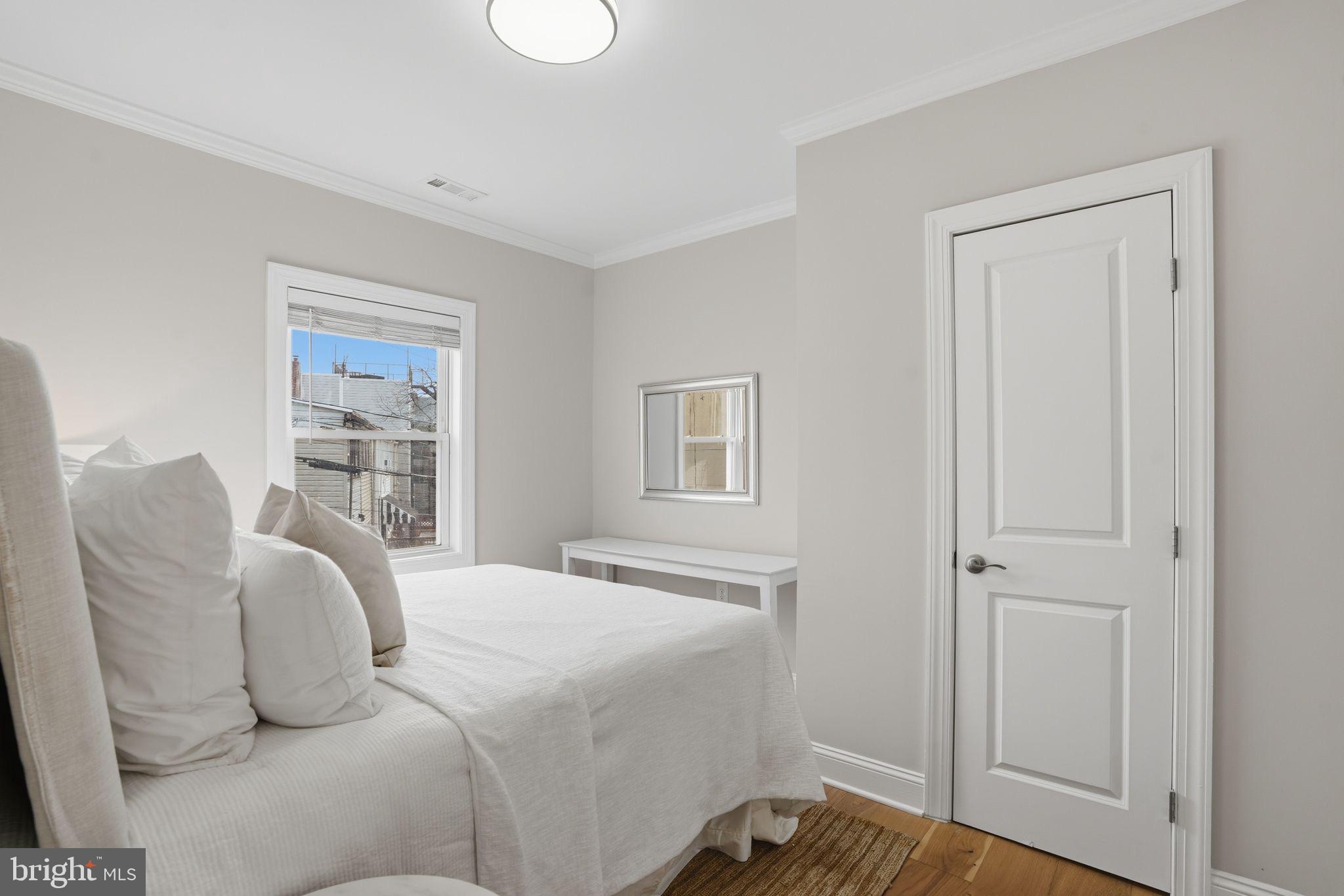 1208 Shepherd Street Northwest Washington, DC 20011 - Photo 22 of 27 a bedroom with a bed and a window