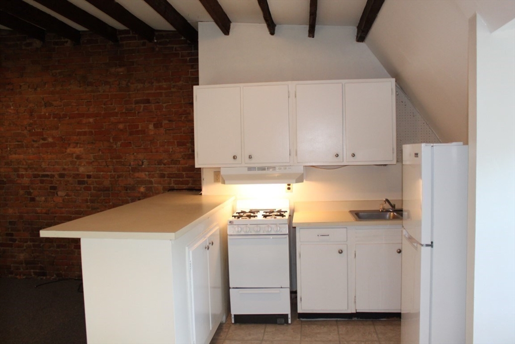 19 East Springfield Street, Unit 3 Boston, MA 02118 - Photo 2 of 10 a utility room with cabinets washer and dryer