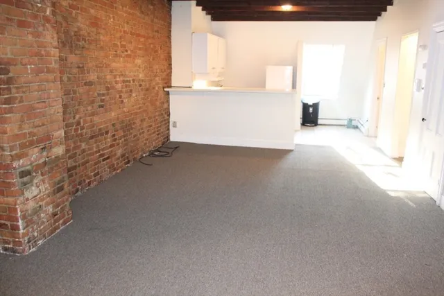 a view of an empty room and a window