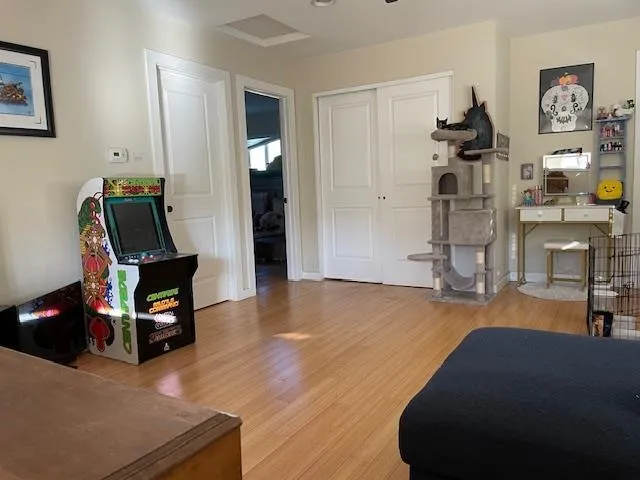 a living room with furniture and a wooden floor