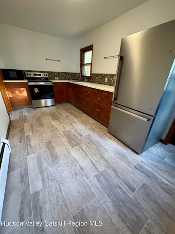 a kitchen with granite countertop a refrigerator and a stove
