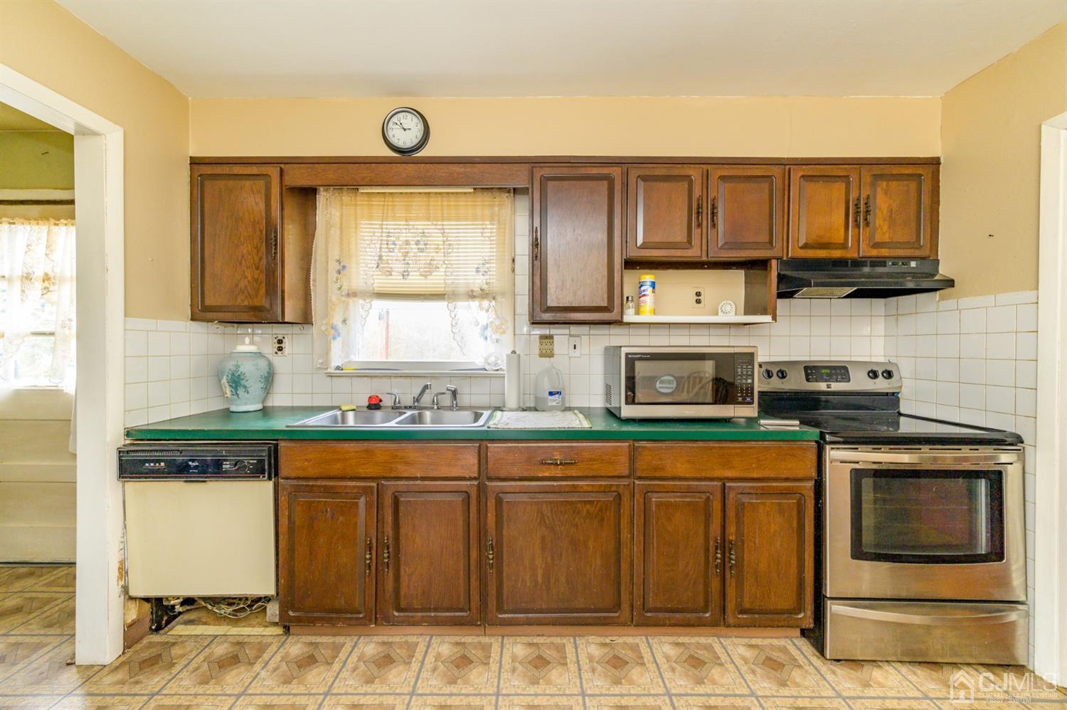 780 Monmouth Road Cream Ridge, NJ 08514 - Photo 14 of 35 a kitchen with stainless steel appliances granite countertop a stove a sink and a microwave