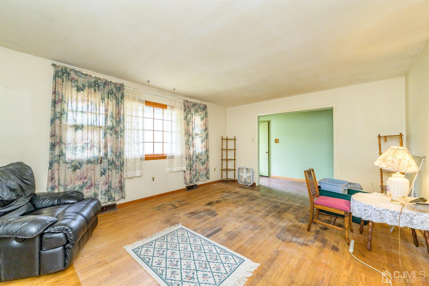 780 Monmouth Road Cream Ridge, NJ 08514 - Photo 4 of 35 a spacious bedroom with a bed and wooden floor